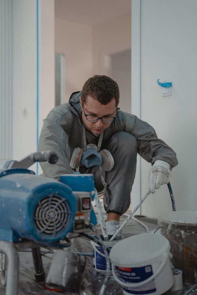 Professional painter at work on a building exterior in Calgary